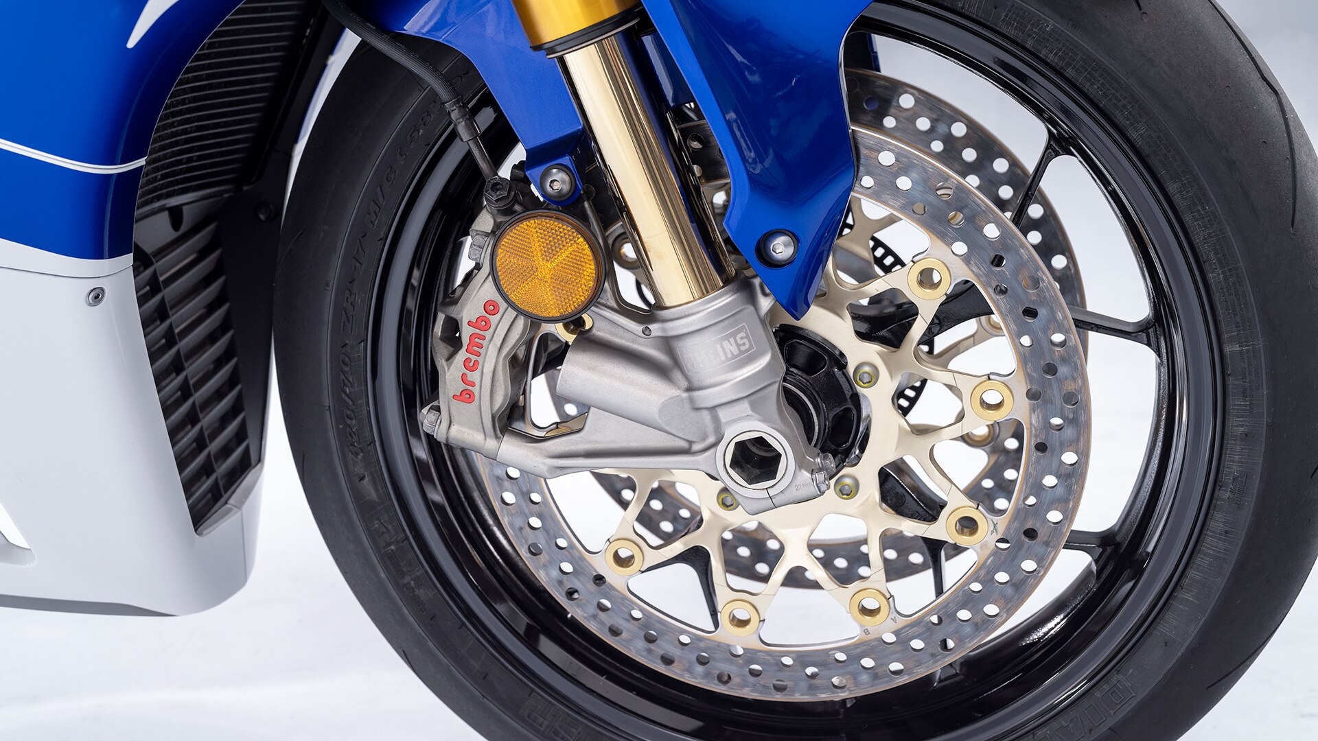 Close-up of front tire. Close-up of Brembo Stylema four-piston radial mount brake calipers.