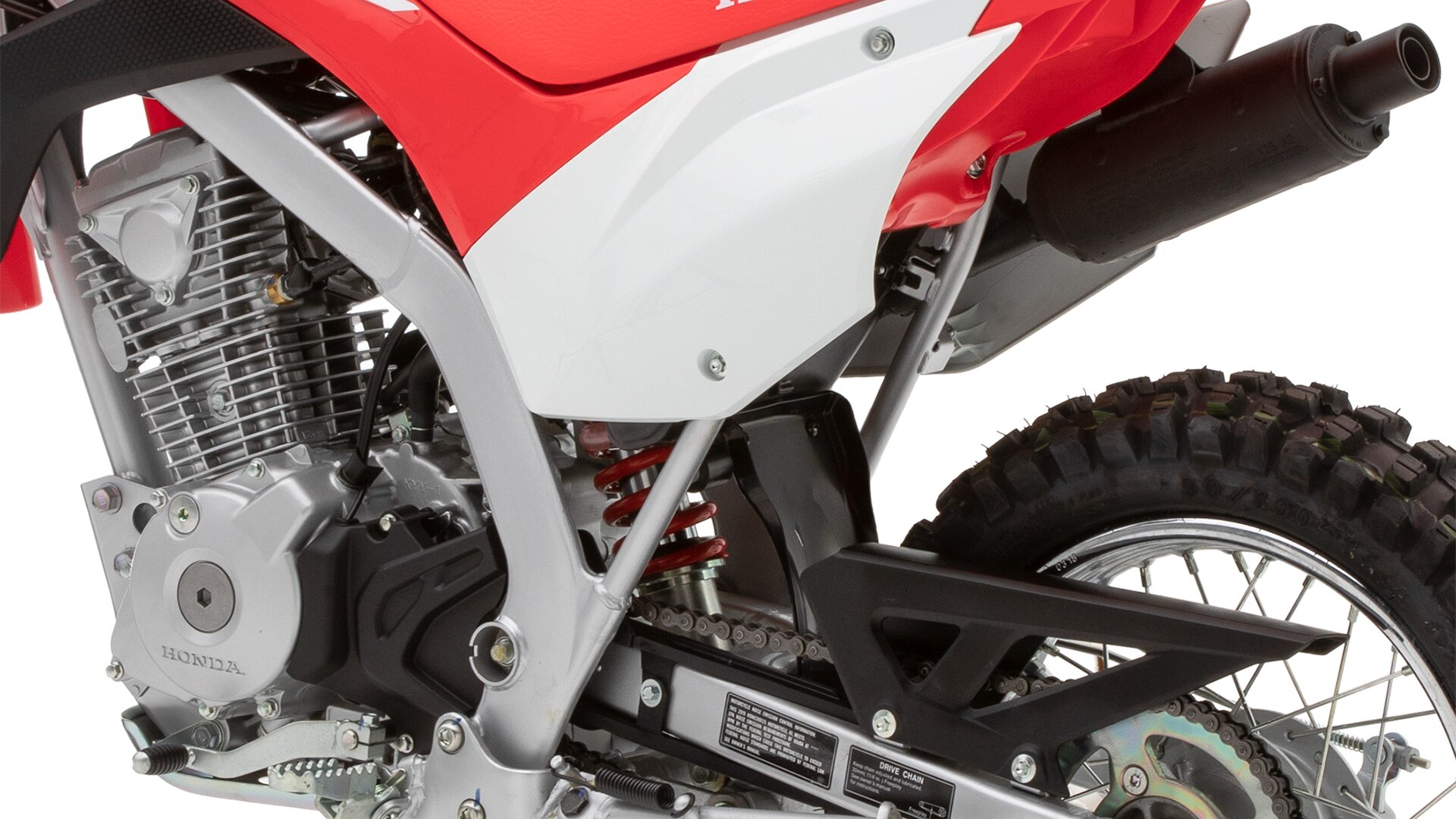 Close-up of CRF125F rear fairing, frame and 4-stroke engine.