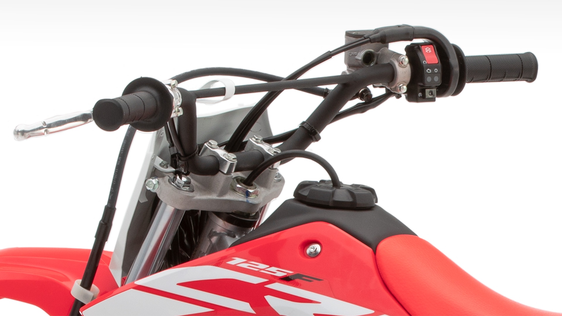 Close-up of handlebars and electric starter button.