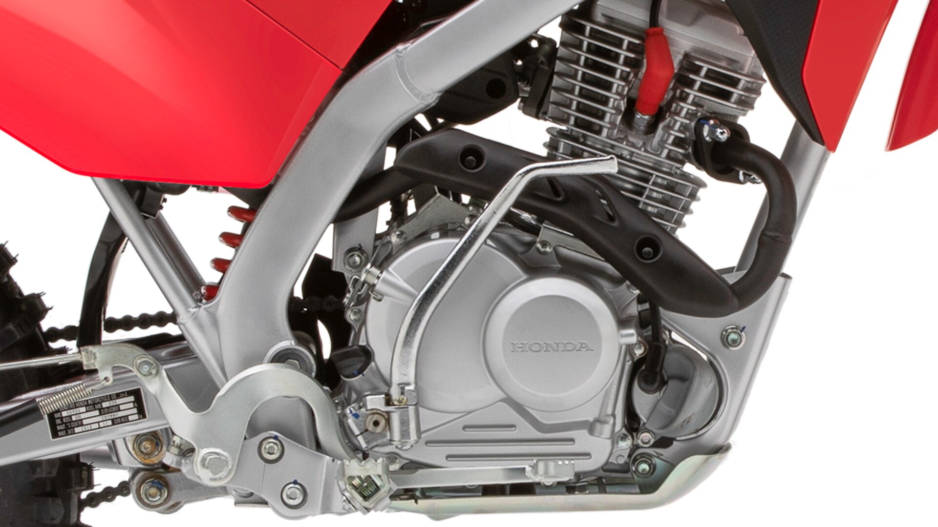 Close-up of CRF125FB rear fairing, frame and 4-stroke engine.